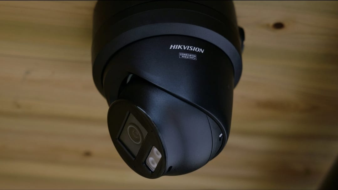 Hikvision black turret CCTV camera installed under eaves